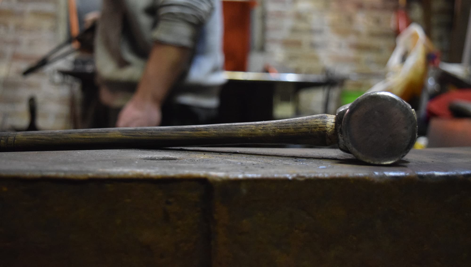 Blacksmith hammer on anvil in workshop